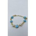 Bracciale in acciaio dorato con perle e pietre dure color turchese